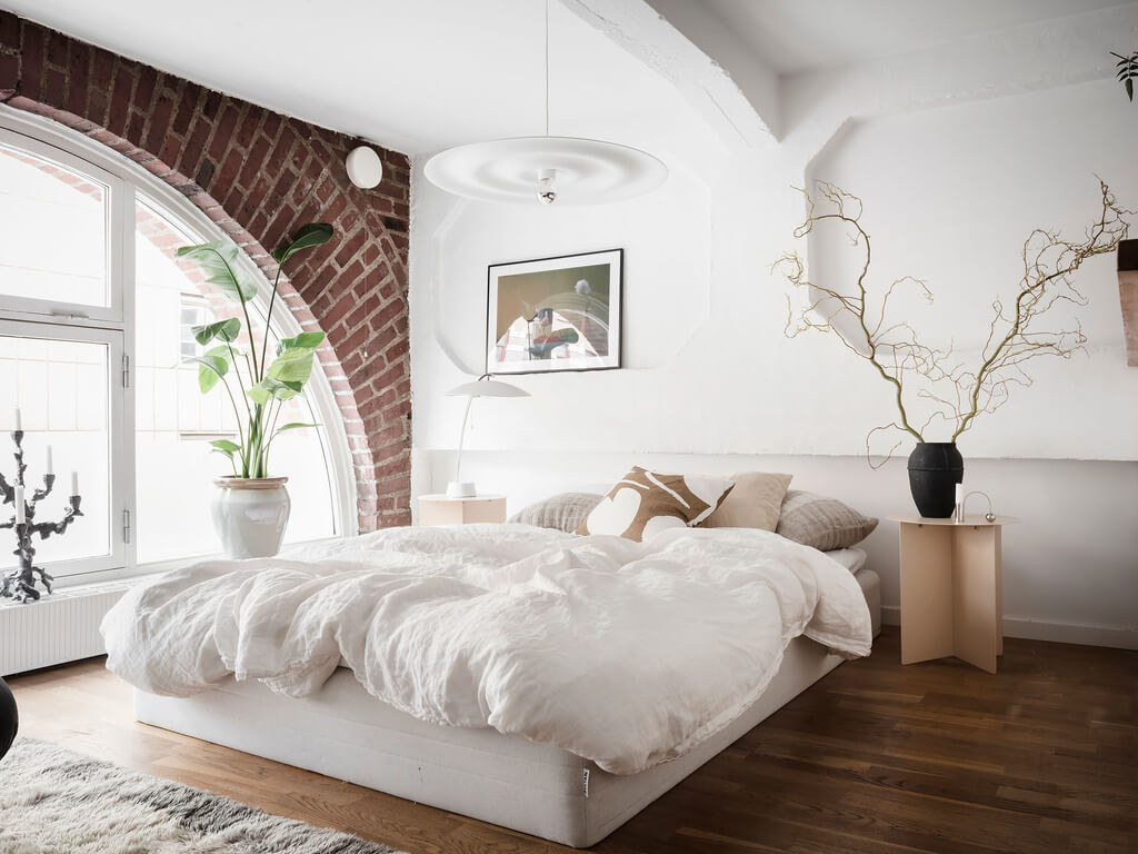 Best of 2023: Loft Apartments 7 bedroom-wooden-floor-brick-wall-arched-window-white-bedding-nordroom
