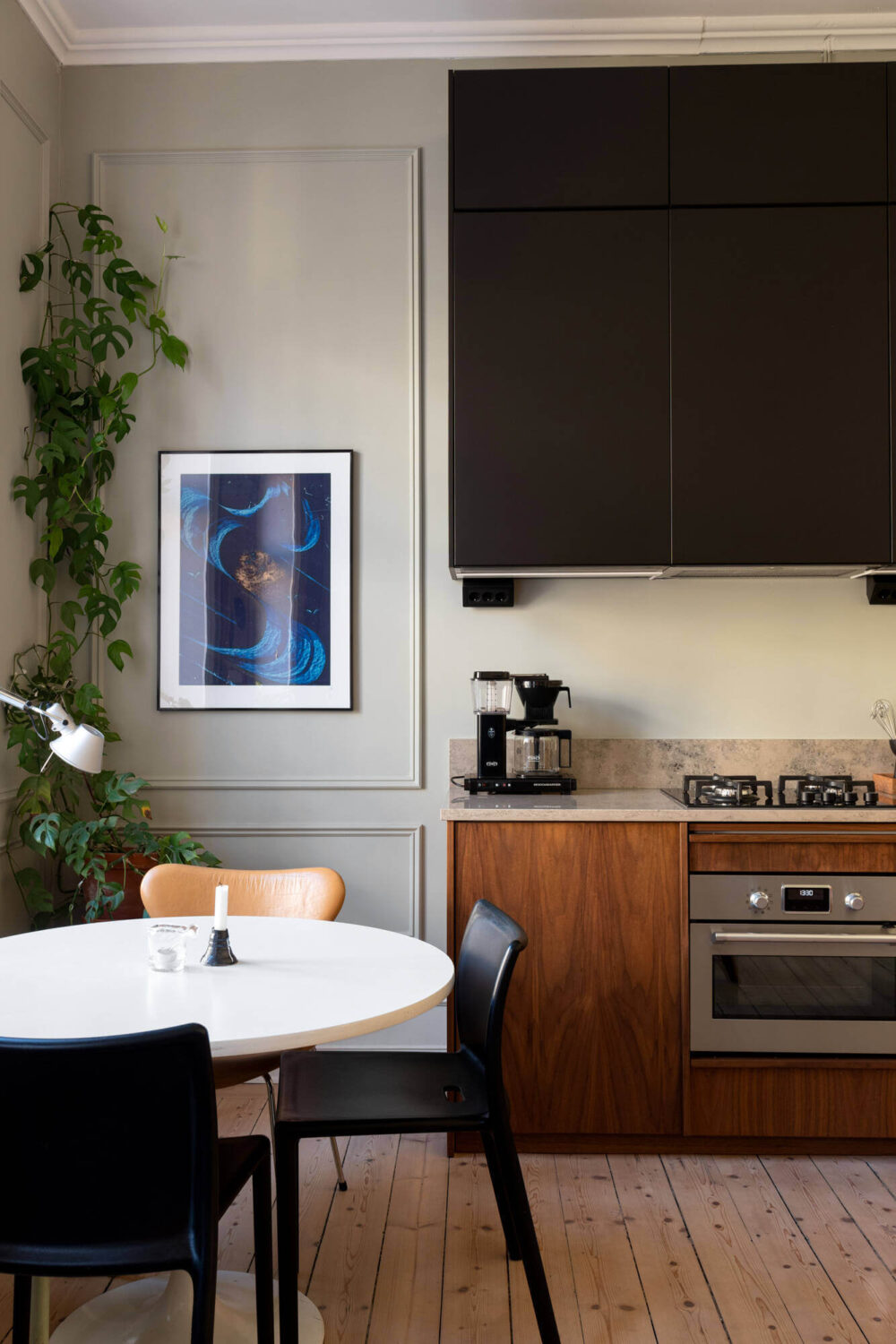 A Small Stockholm Apartment with Lovely Natural Light 2 kitchen round dining table wooden floor walnut cabinets