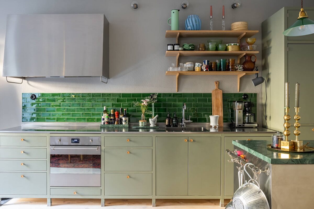 A Swedish Townhouse with a Light Green Kitchen 3 mint-green-kitchen-glossy-green-backsplash-tiles-shelves-nordroom