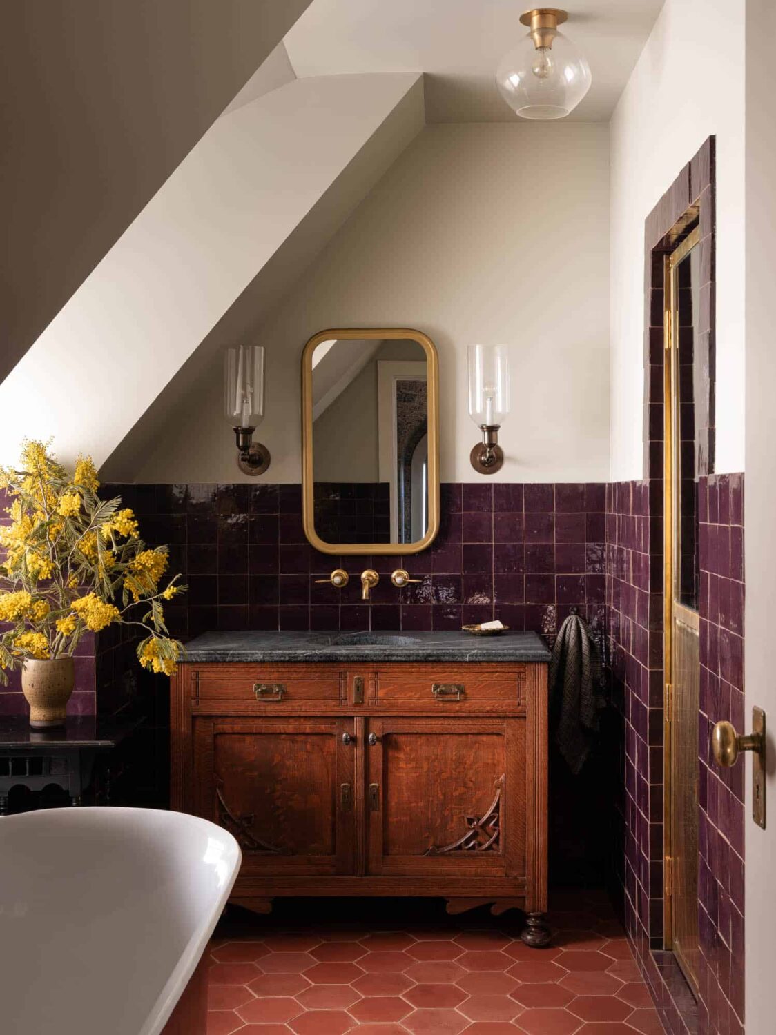 A Cozy Pied-à-Terre with Slanted Ceilings and Wallpaper 18 bathroom-antique-sanity-soapstone-sink-purple-tiles-hexagon-terracotta-floor-tiles-slanted-ceiling-nordroom