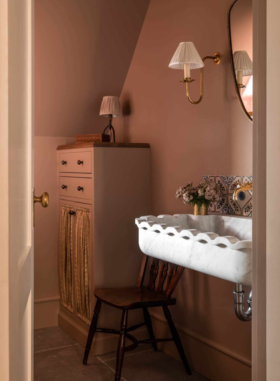 A Cozy Pied-à-Terre with Slanted Ceilings and Wallpaper 23 bathroom-slanted-ceiling-pink-walls-sink-nordroom