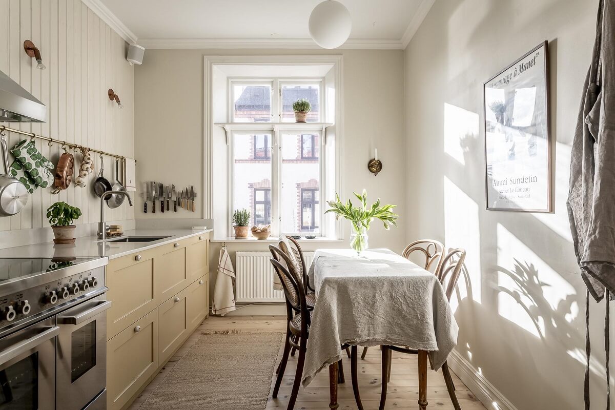Glidden & PPG Color of the Year 2024: Limitless 26 kitchen-dining-table-pale-yellow-cabinets-nordroom