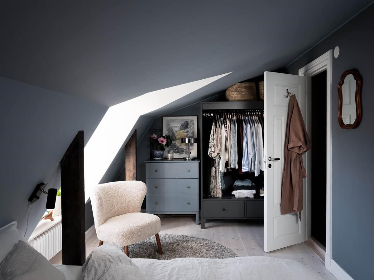 A Scandinavian Duplex That Blends Old and New 17 open-wardrobe-attic-apartment-blue-walls-nordroom