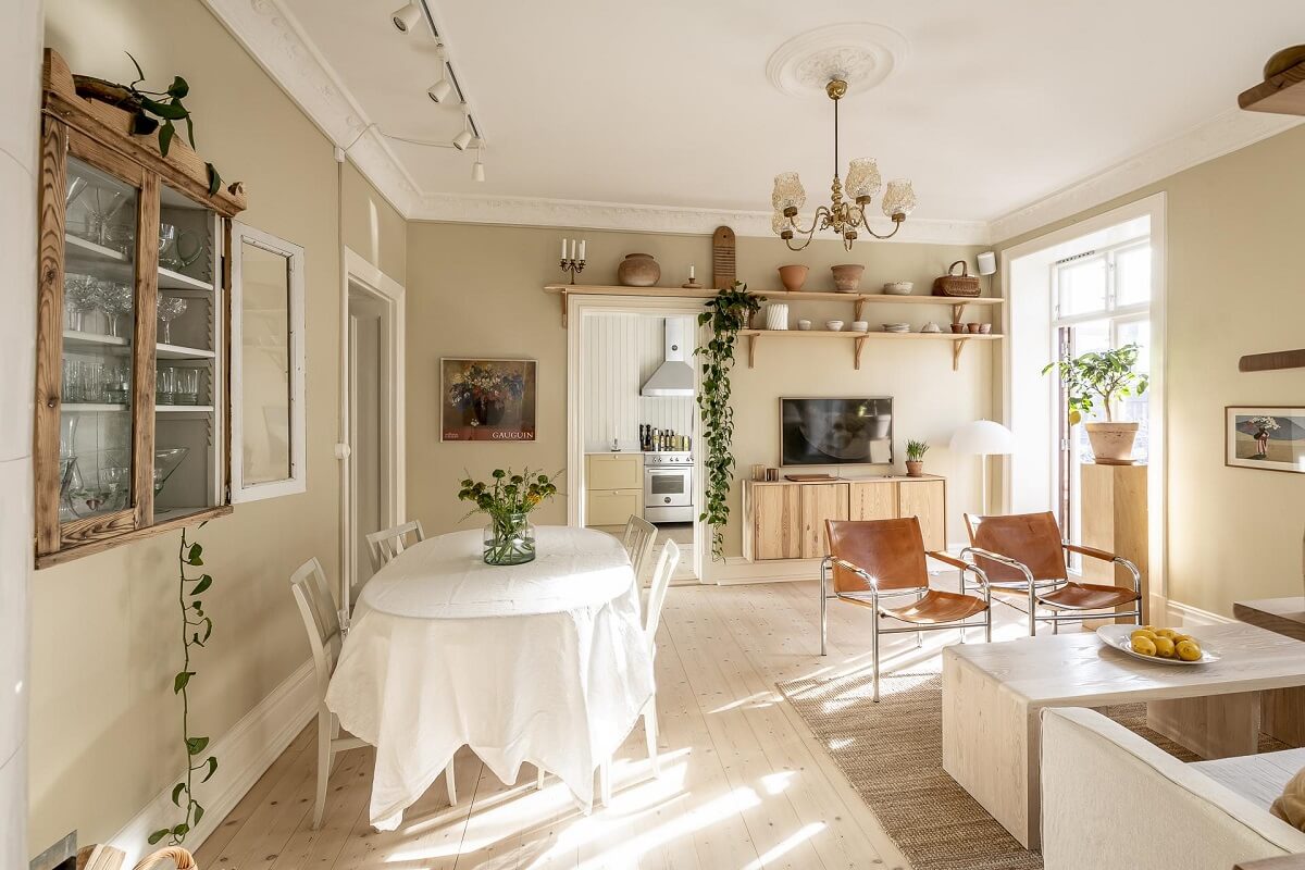 A Scandinavian Apartment with a Pale Yellow Kitchen 10 serene-living-room-beige-walls-wooden-floor-natural-light-nordroom