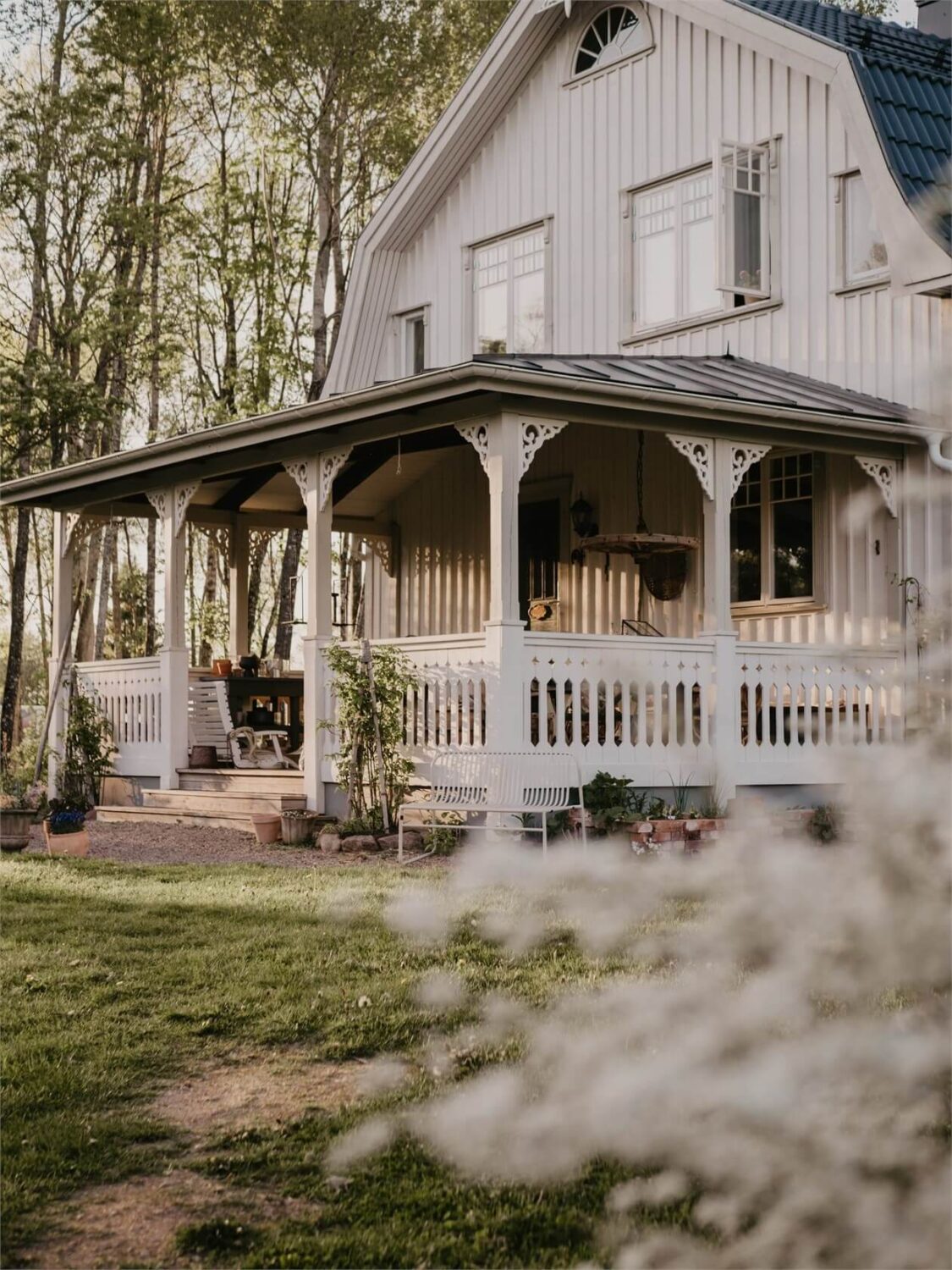 Best of 2023: Outdoor Spaces 9 white-swedish-country-house-veranda-flower-garden-nordroom