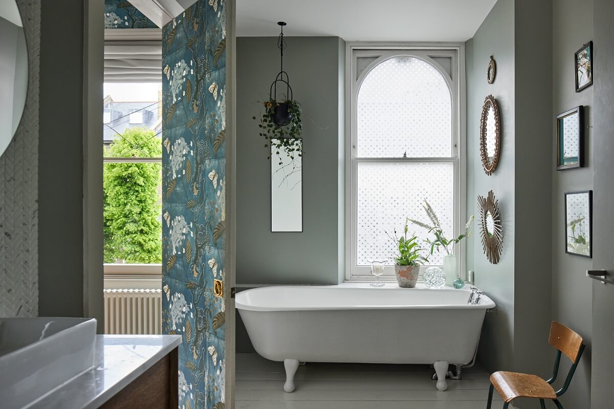 A Light Victorian Townhouse with Teal Reading Room 16 bathroom-light-gray-walls-freestanding-bath-arched-window-nordroom