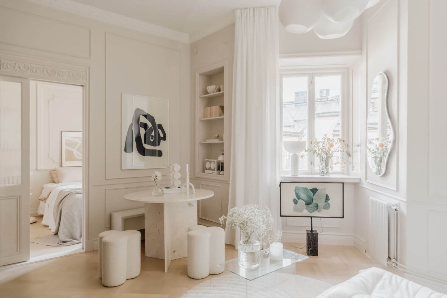 A Small Beige Apartment with Niches and Built-in Storage 1 beige-living-room-small-round-dining-table-built-in-bookshelfs-nordroom