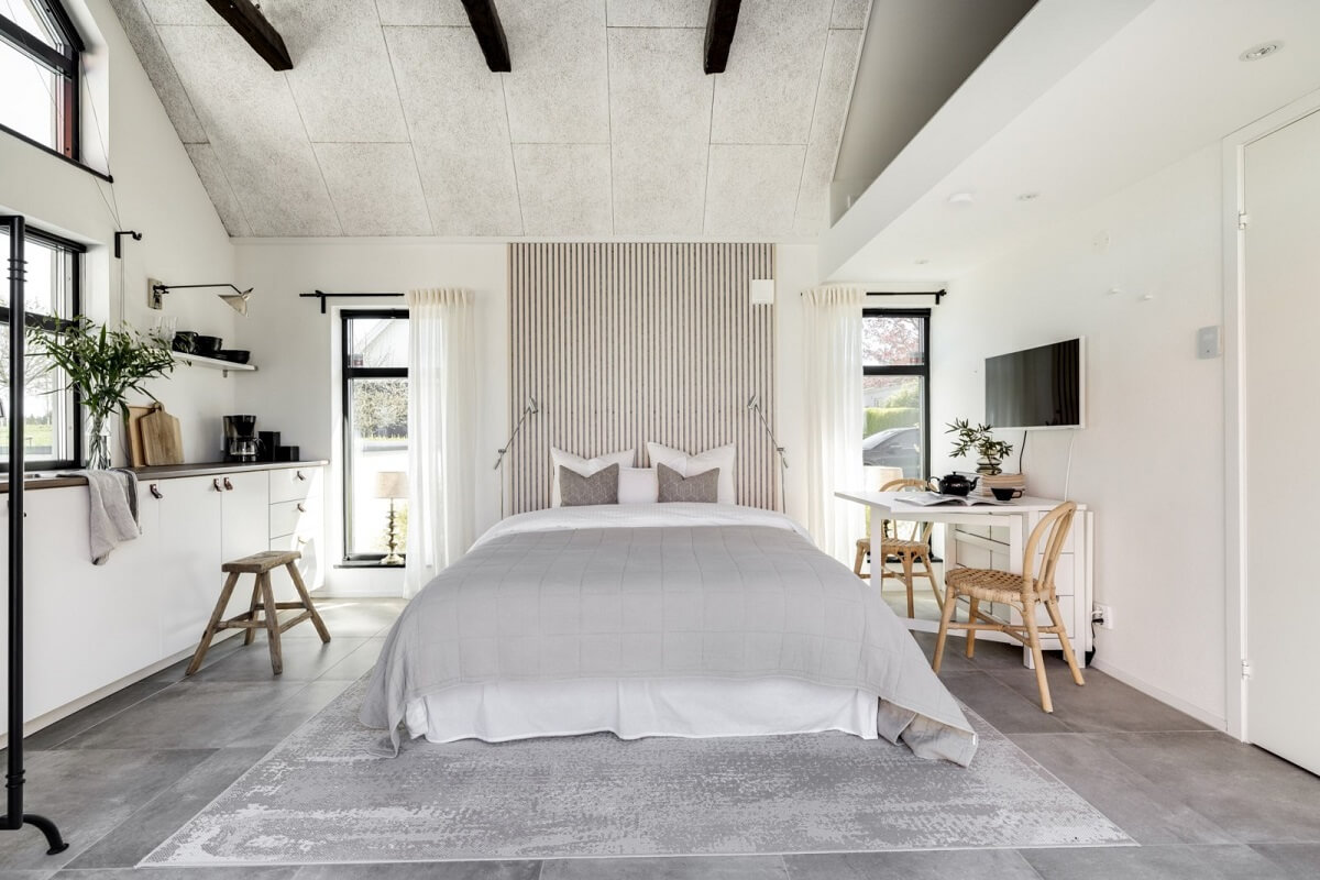 A Monochrome Swedish Villa with High Ceilings 33 guest-house-light-gray-white-bed-kitchen-nordroom