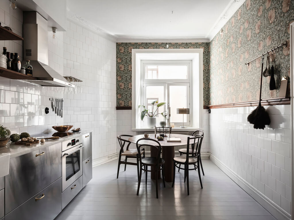 A Scandi Home with Stainless Steel Kitchen and Wallpaper 1 kitchen-stainless-steel-cabinets-white-tiles-round-dining-table-nordroom