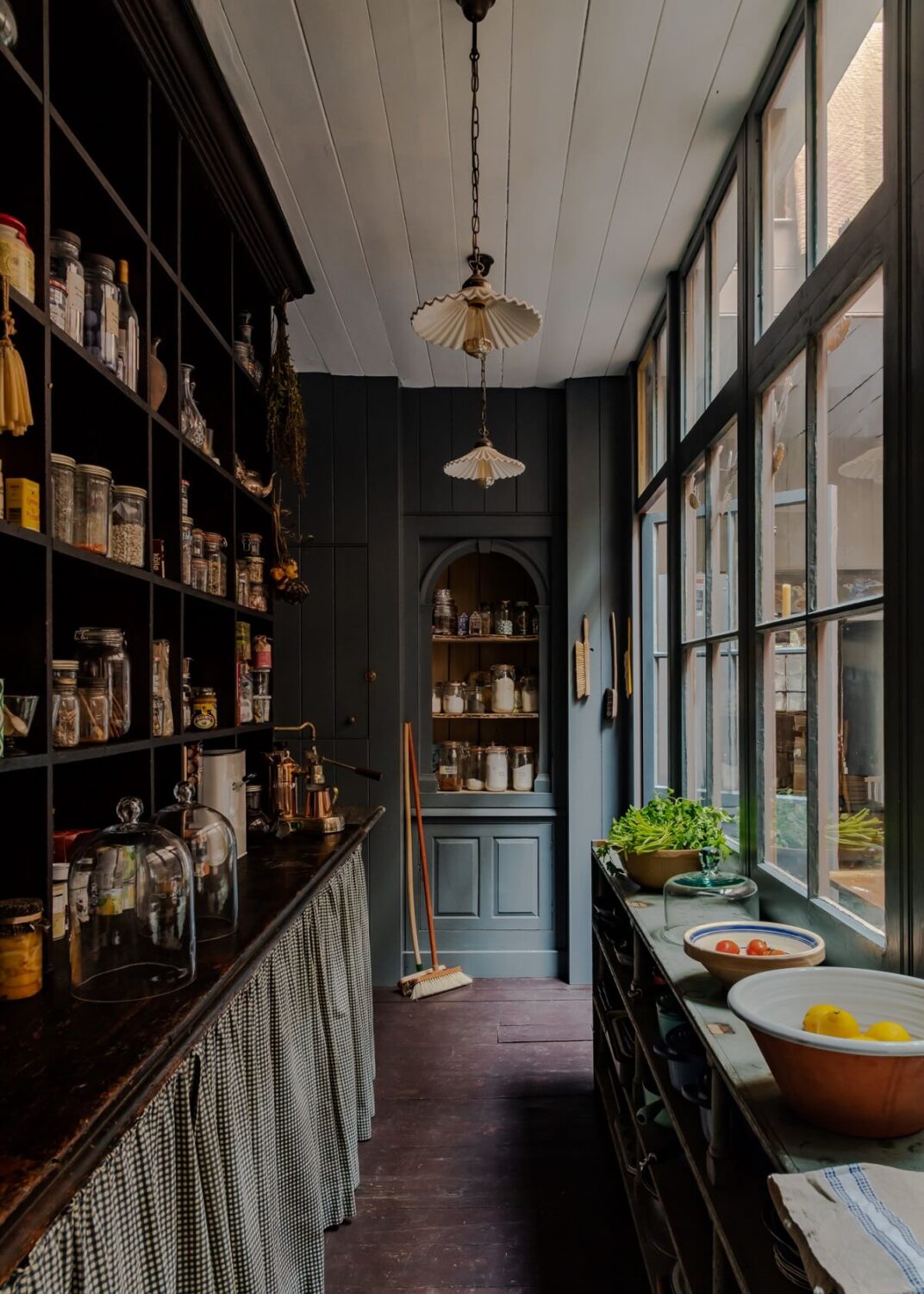 Best of 2023: Kitchens 35 moody-dark-gray-pantry-skirting-shelves-glass-wall-nordroom