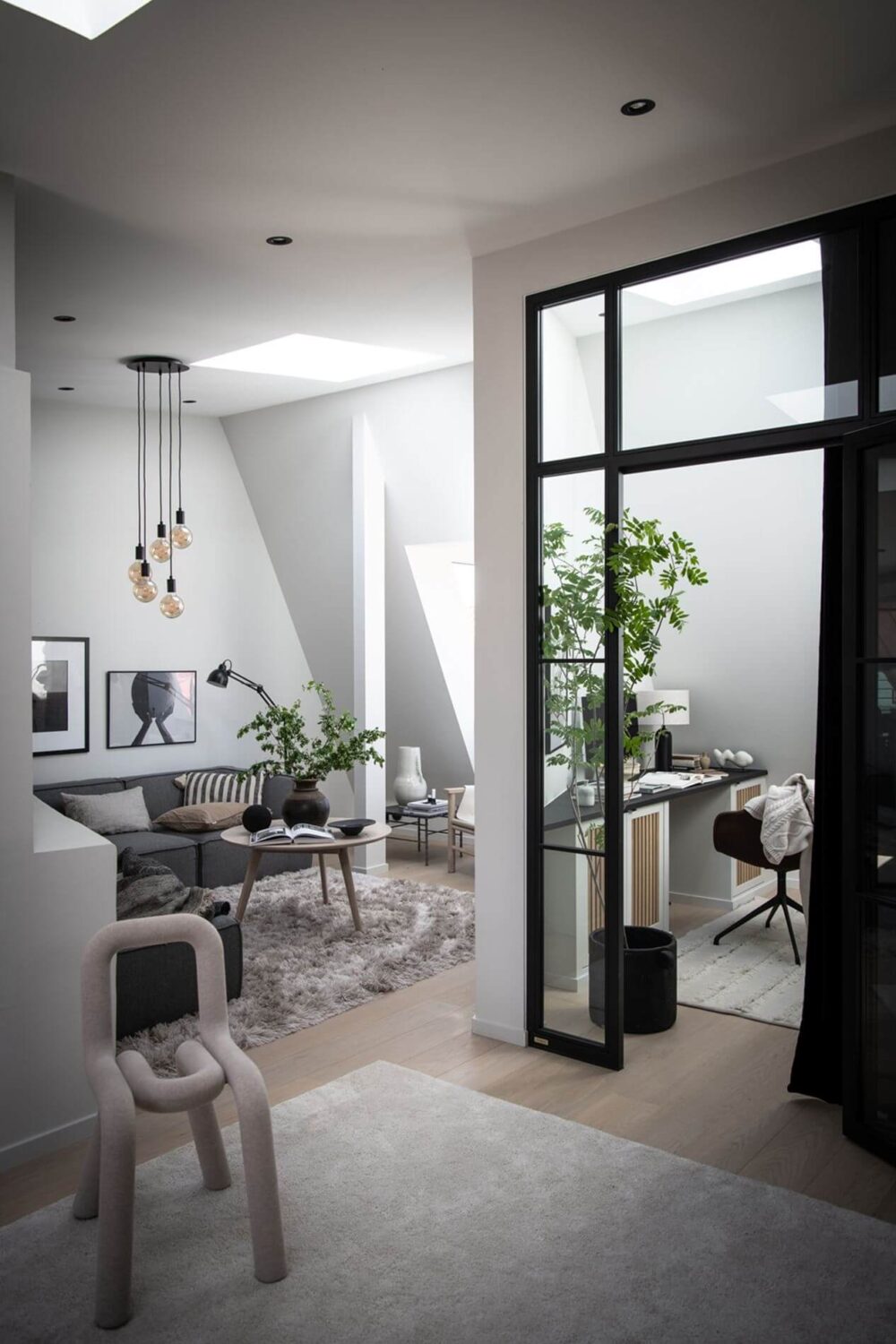 Best of 2023: Home Offices 3 open-plan-attic-apartment-industrial-elements-glass-steel-door-home-office-nordroom