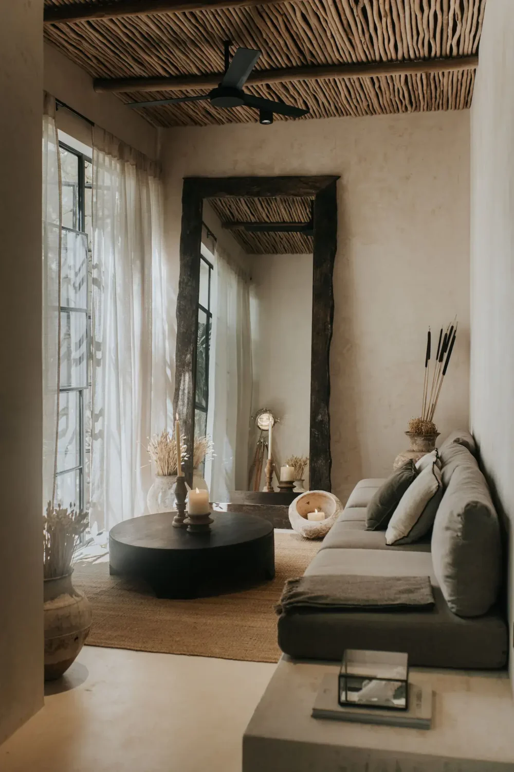Rustic Wooden Elements in a Stylish Tulum Airbnb 7 small-natural-living-room-large-wooden-mirror-wooden-stick-ceiling-nordroom
