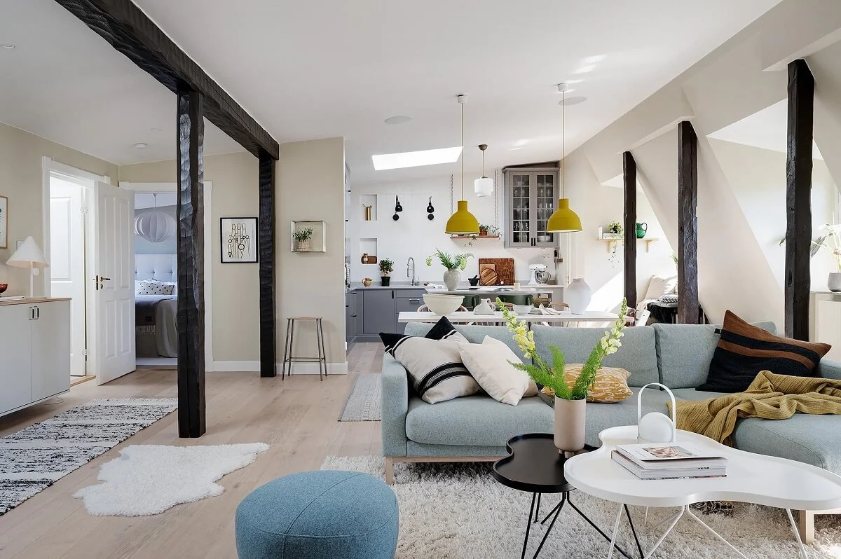 A Modern Scandinavian Attic Apartment 2 social-living-space-light-blue-couch-wooden-beams-nordroom