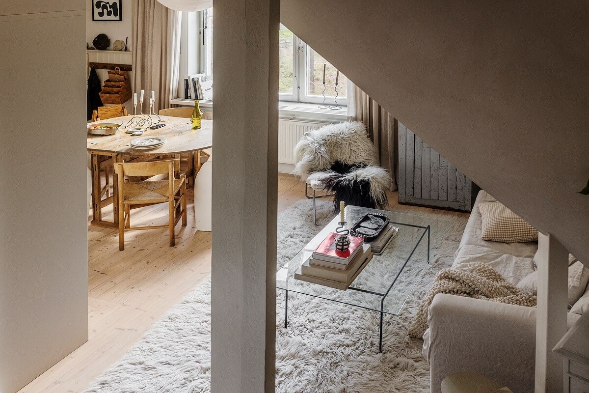 A Charming Attic Apartment with High Ceilings 9 social-living-space-open-kitchen-large-rug-nordroom