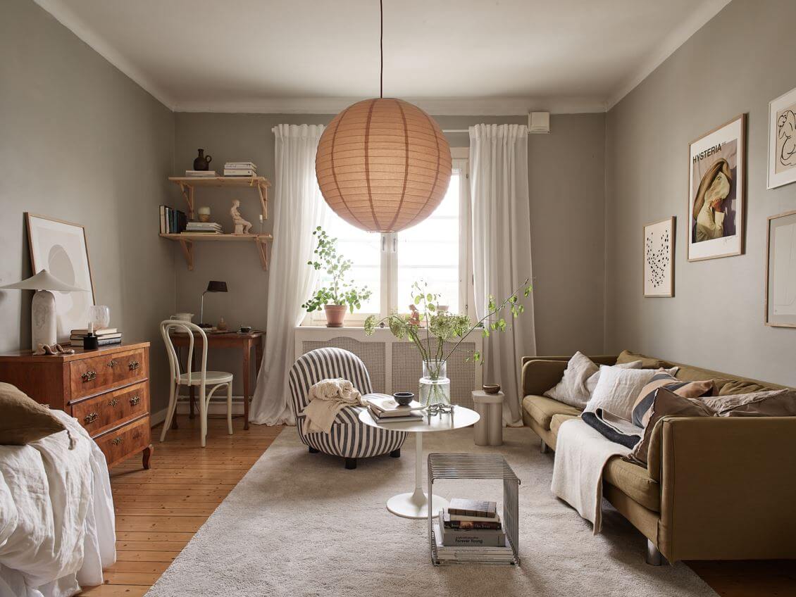 A Small Studio Apartment with Gray Walls 1 studio-apartment-gray-walls-green-sofa-desk-shelves-nordroom