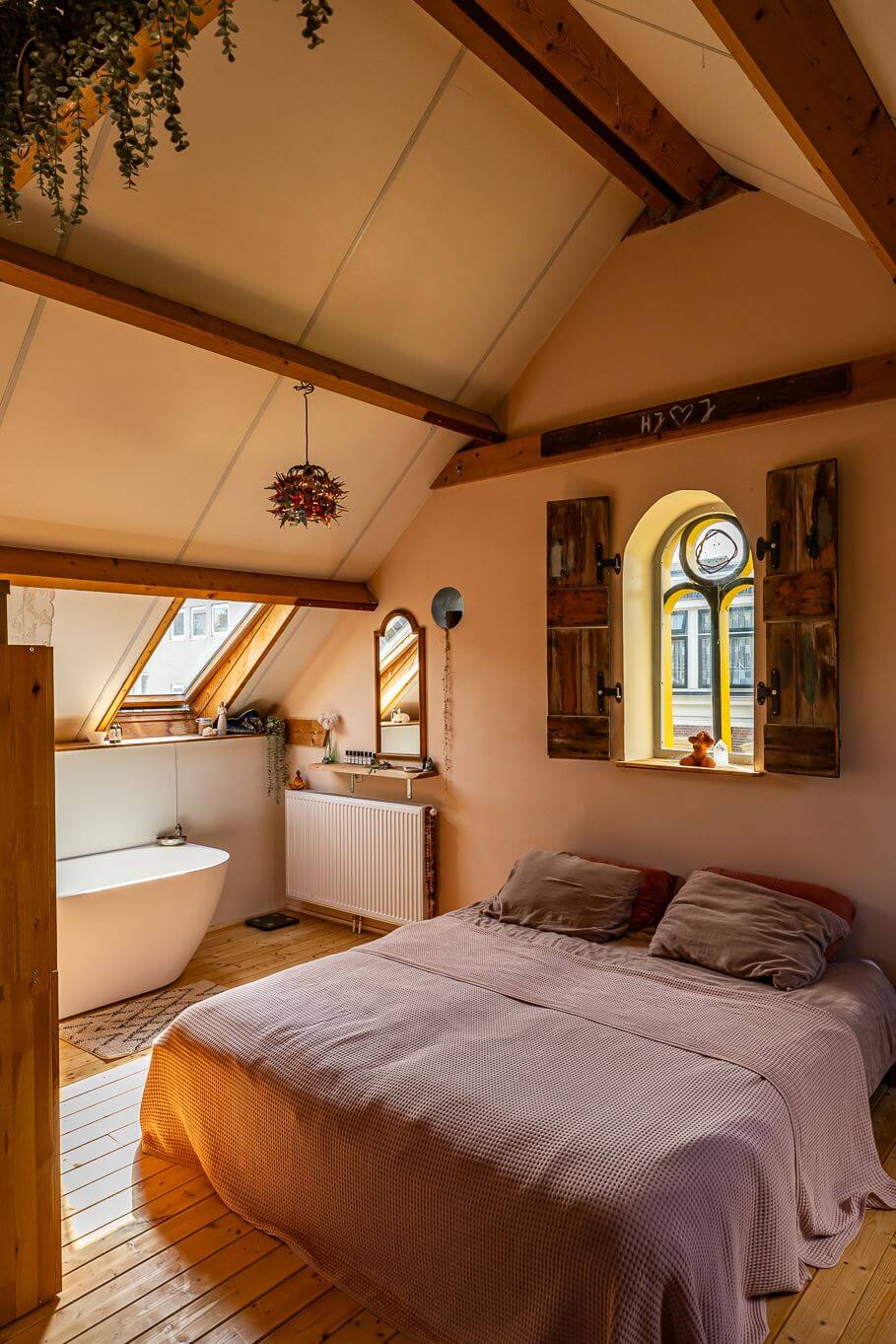 A Colorful Church Conversion in The Netherlands 22 attic-bedroom-wooden-shutters-exposed-wooden-beams-freestanding-bath-nordroom