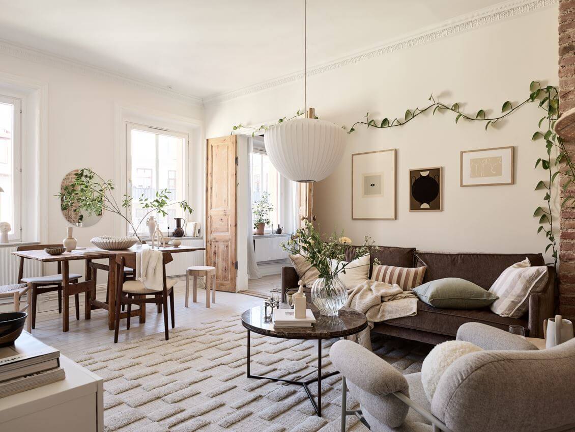 A Swedish Apartment with an Exposed Brick Wall 1 living-room-with-dining-table-large-rug-nordroom
