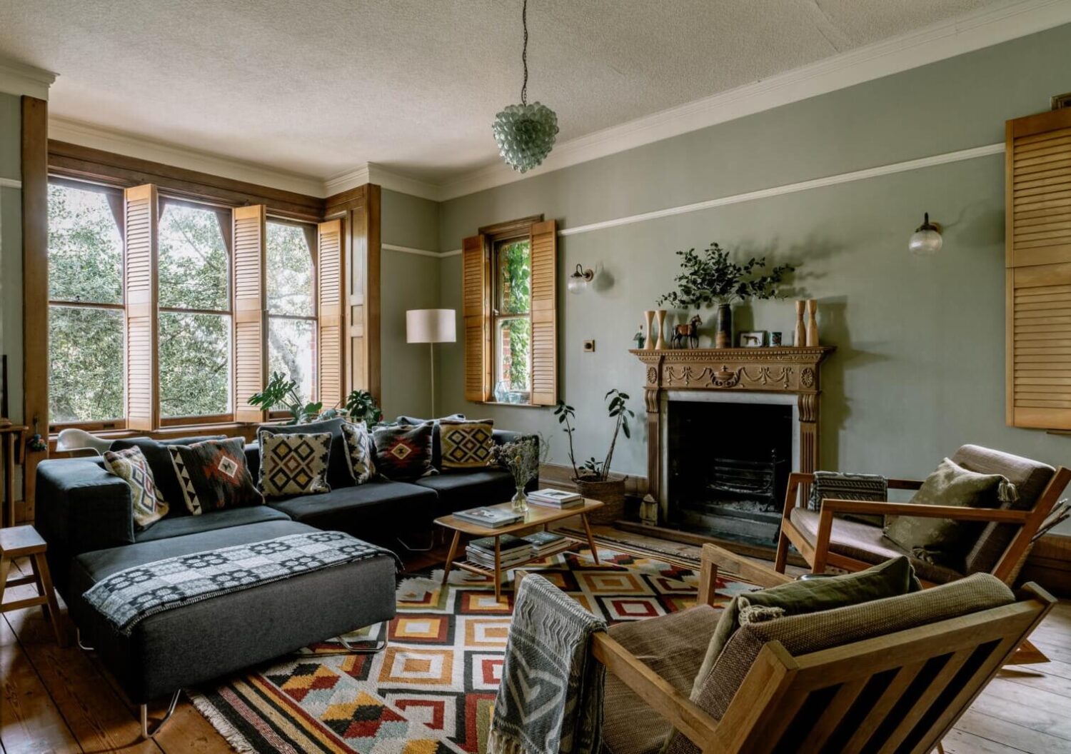 A Warm Living Room in a Historic English Home 1 warm-living-room-colorful-textiles-wooden-shutters-nordroom