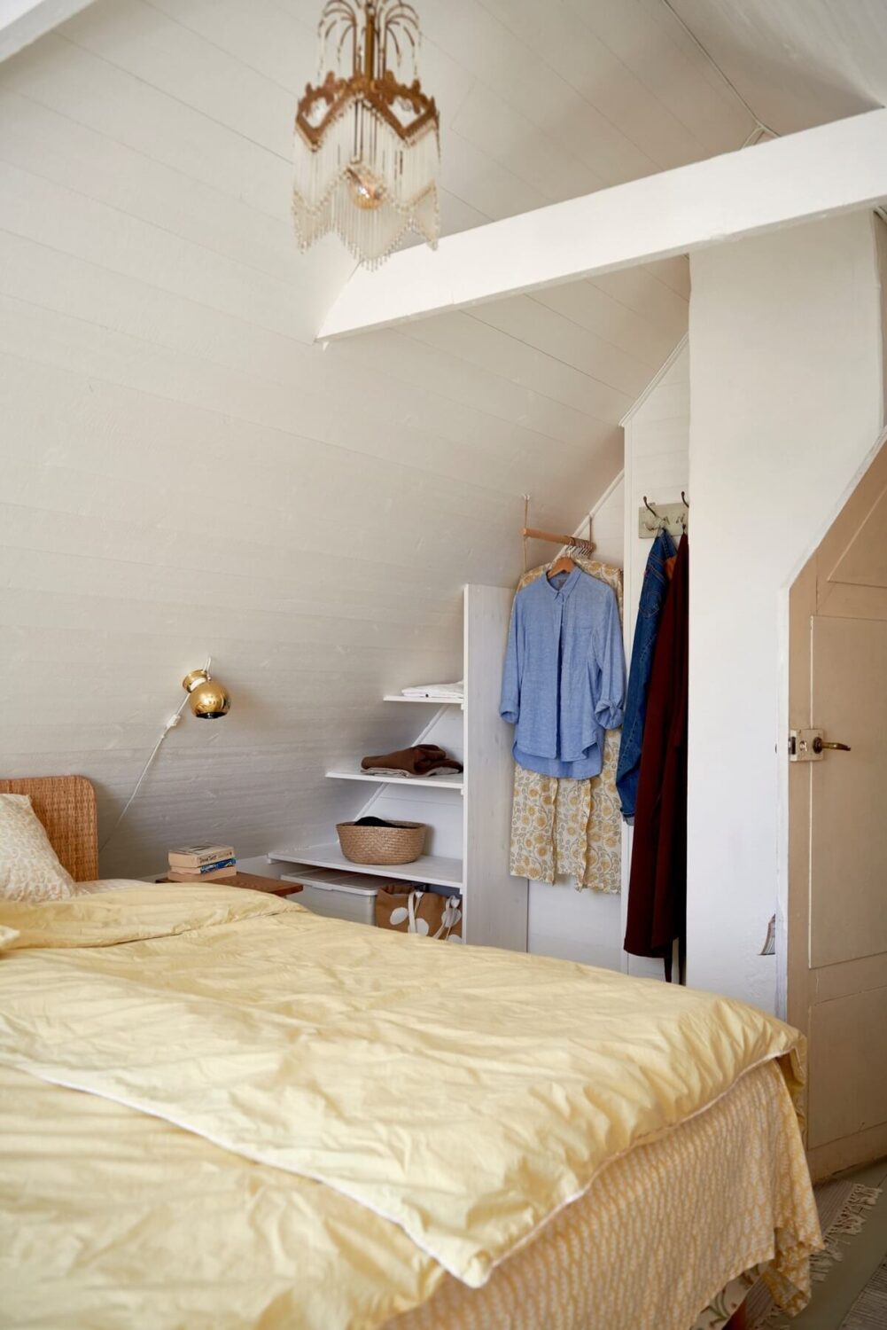 Natural Light in a Charming Swedish Country House 13 white-attic-bedroom-open-wardrobe-yellow-bedding-nordroom