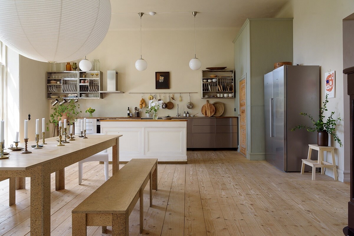 Natural Colors in a Swedish School Conversion 12 large-kitchen-stainless-steel-cabinets-wooden-dining-table-benches-nordroom