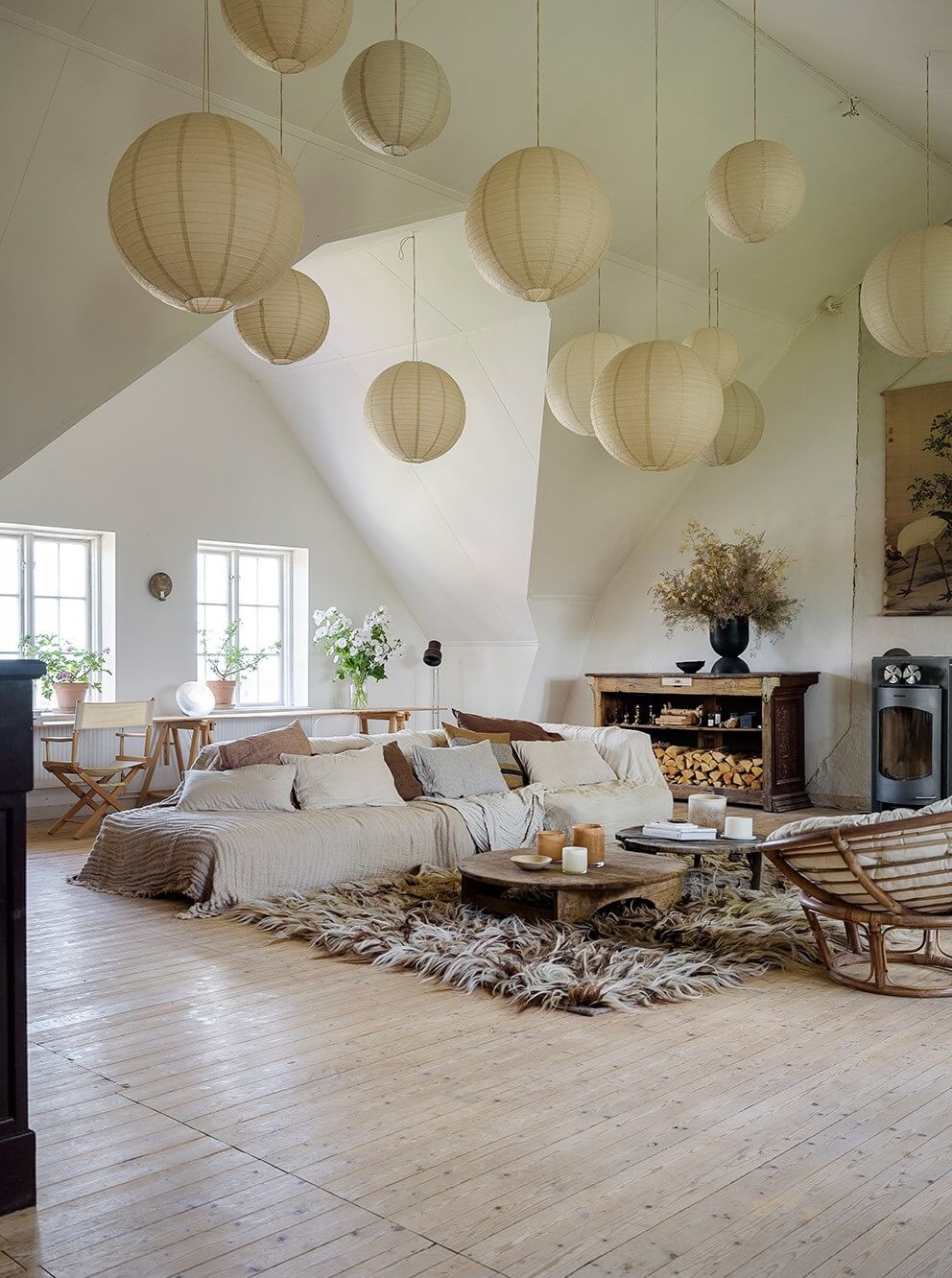 Natural Colors in a Swedish School Conversion 1 open-plan-living-room-slanted-celing-pendant-lights-nordroom