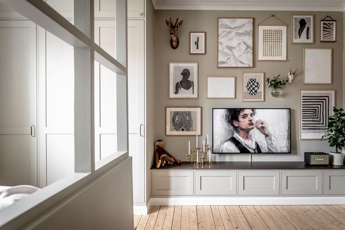 A Serene Studio Apartment with a Brown Kitchen 5 gallery-wall-with-television-studio-apartment-nordroom