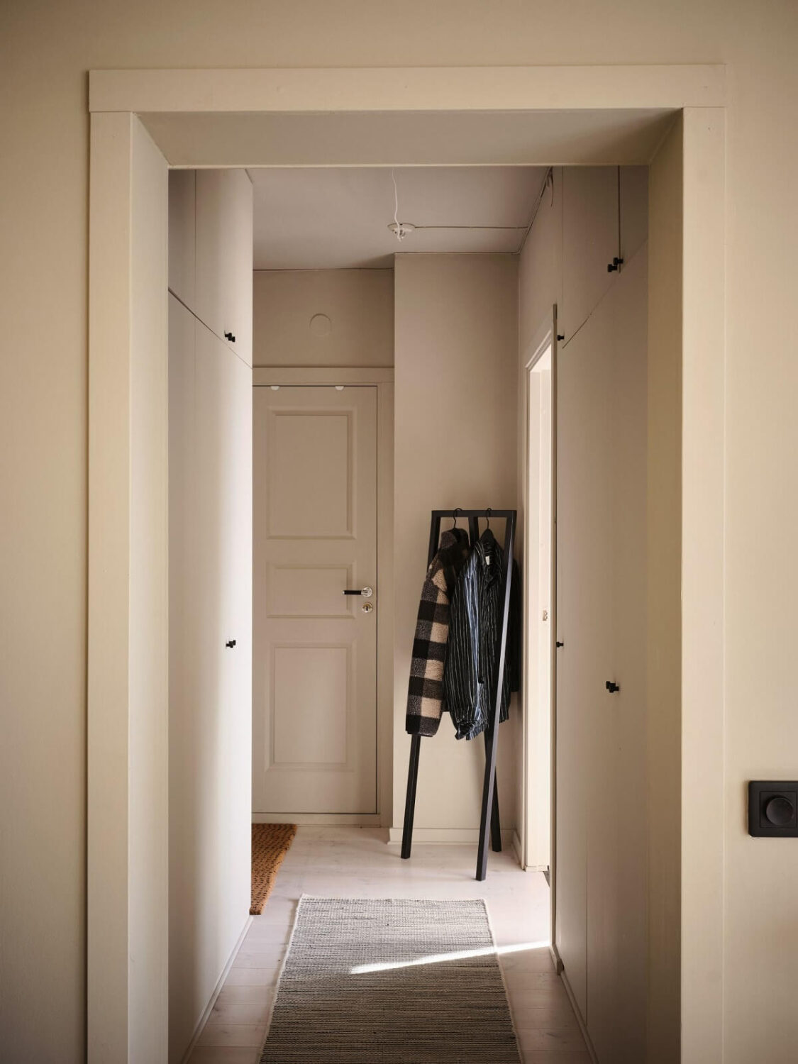A Serene Beige Apartment with Two Balconies 17 gray-hallway-clothing-rack-nordroom