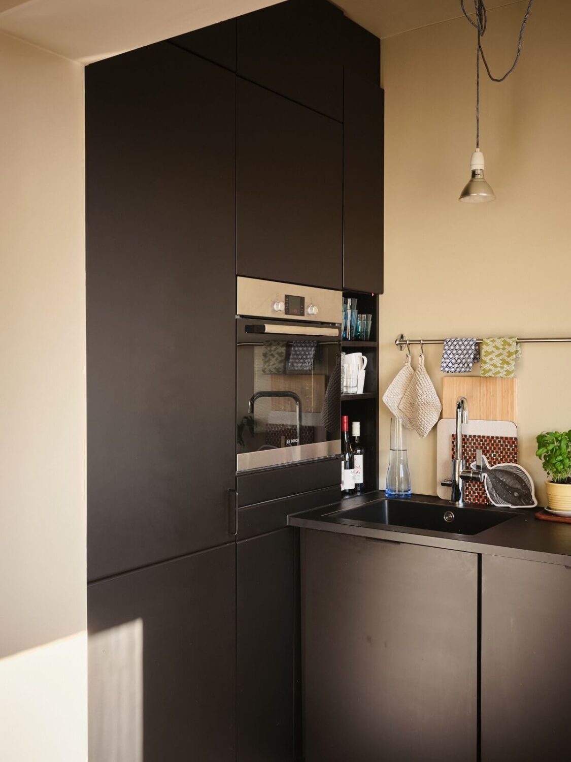 A Serene Beige Apartment with Two Balconies 10 kitchen-modern-black-cabinets-nordroom