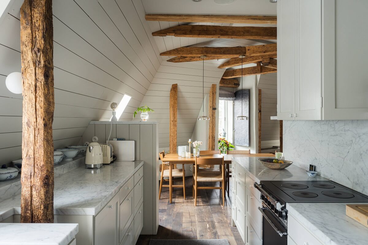 A Stylish Penthouse Apartment with Exposed Beams 10 gray kitchen dining space wooden beams