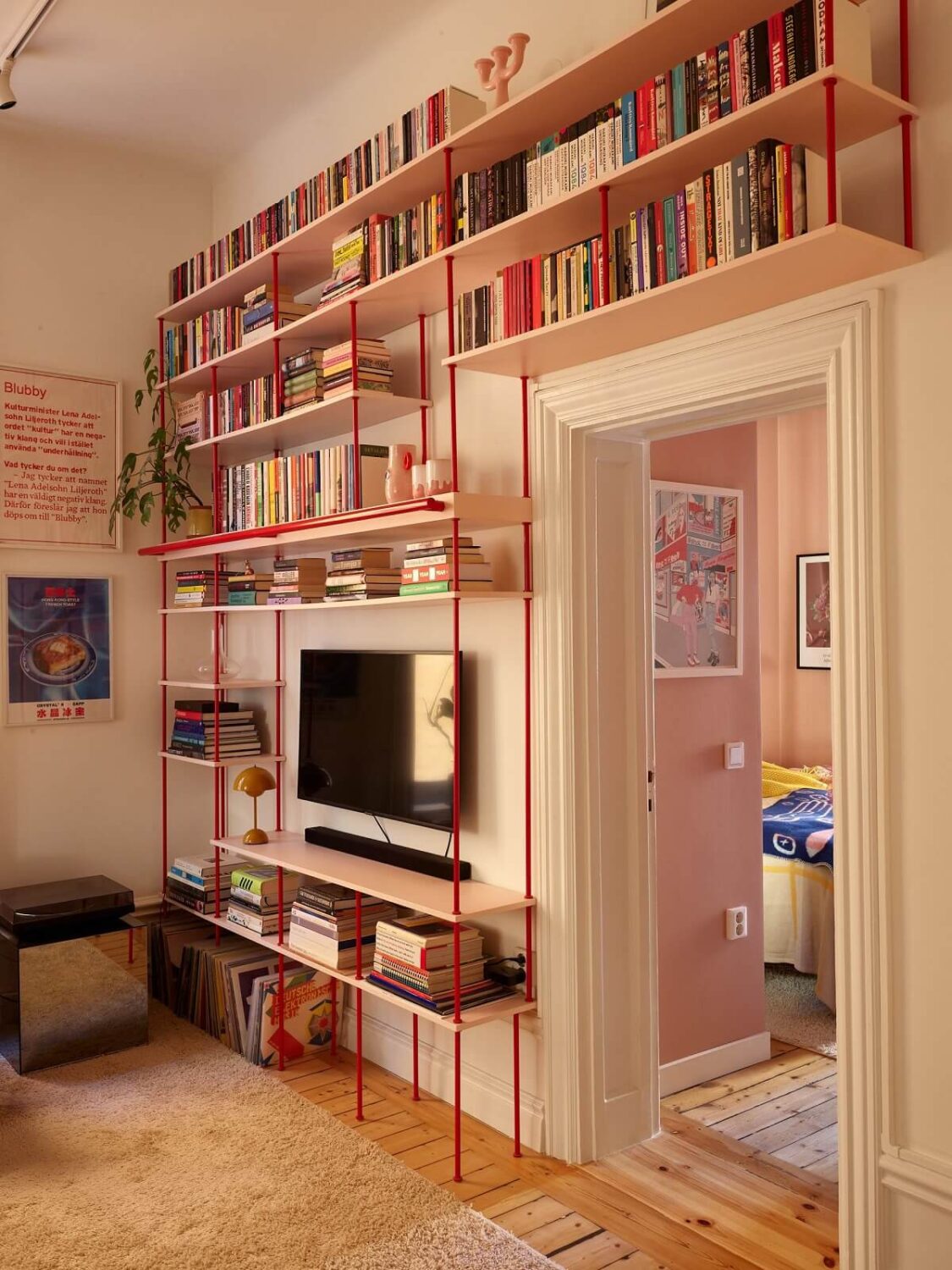 A Small Stockholm Apartment Filled with Color 10 red-wood-bookshelves-colorful-home-nordroom