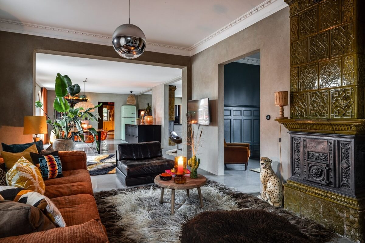A Unique Bohemian Family Home in a Former Swedish Bakery 4 cozy-living-room-burnt-orange-sofa-green-fireplace-nordroom
