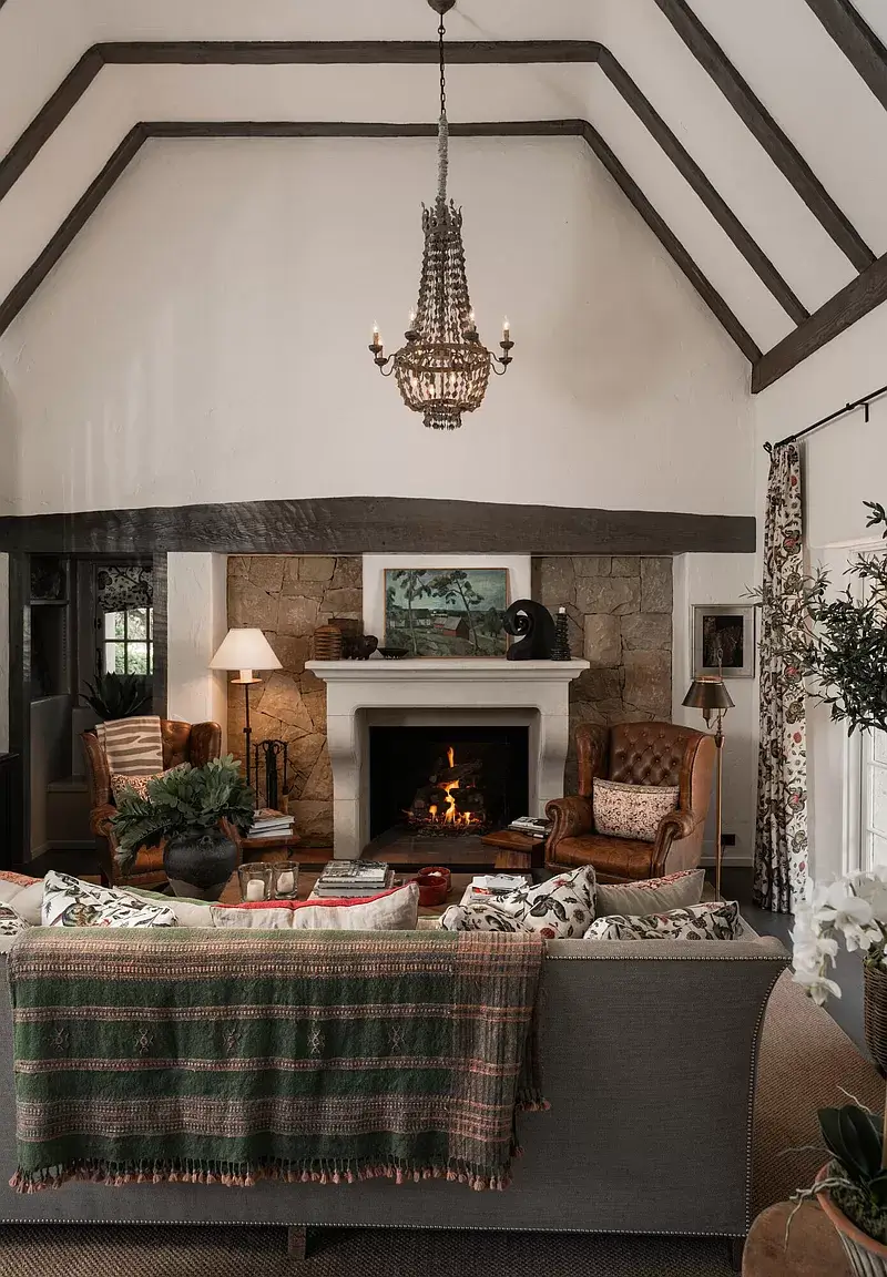 A Cozy Montecito Home Once Owned by Larry David 1 cozy living room fireplace pitched ceiling exposed beams