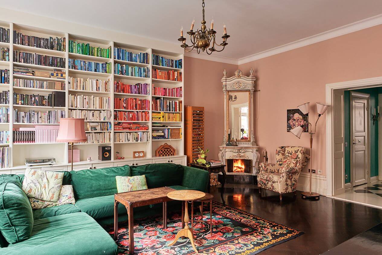 A Romantic Apartment with Original Details 1 green-corner-sofa-bookshelves-pink-walls-nordroom