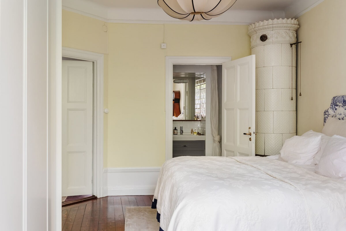 A Cozy Swedish Apartment with a Green Kitchen 27 serene light bedroom beige walls fireplace