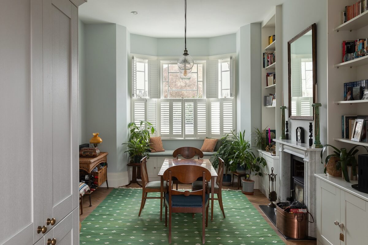dining room with green rug and fireplace nordroom