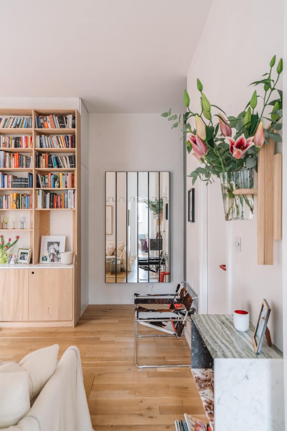 High Ceilings and Modern Design in a Light London Apartment 6 light living room wooden bookcases