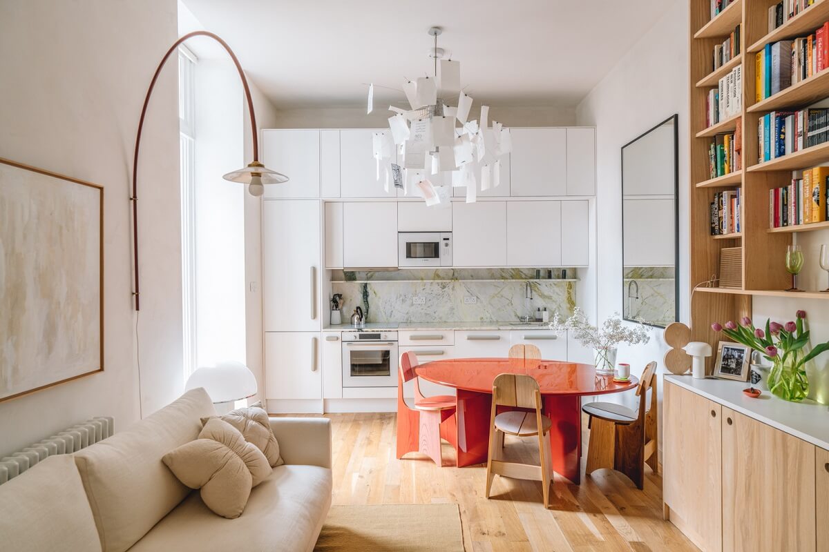 High Ceilings and Modern Design in a Light London Apartment 1 open plan living space red dining table white kitchen