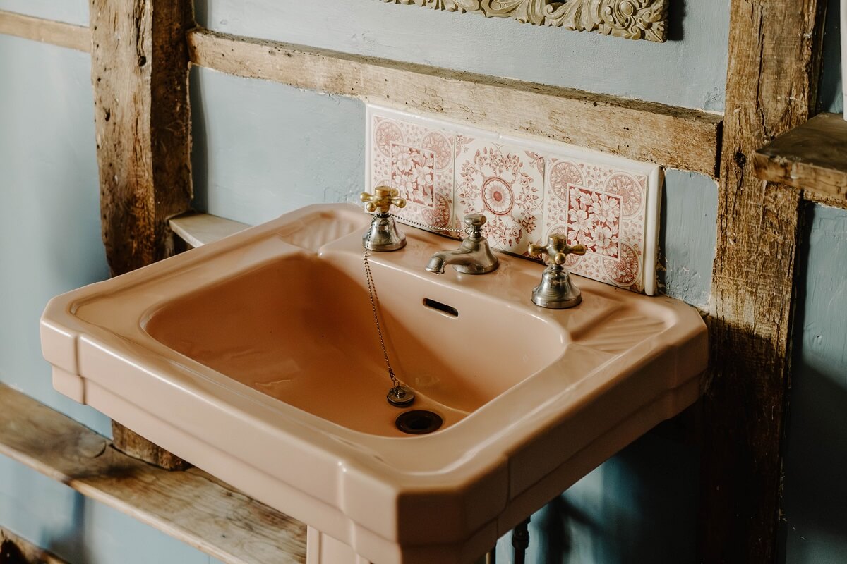 A Cozy Historic English Country House with Exposed Beams 20 pink bathroom sink