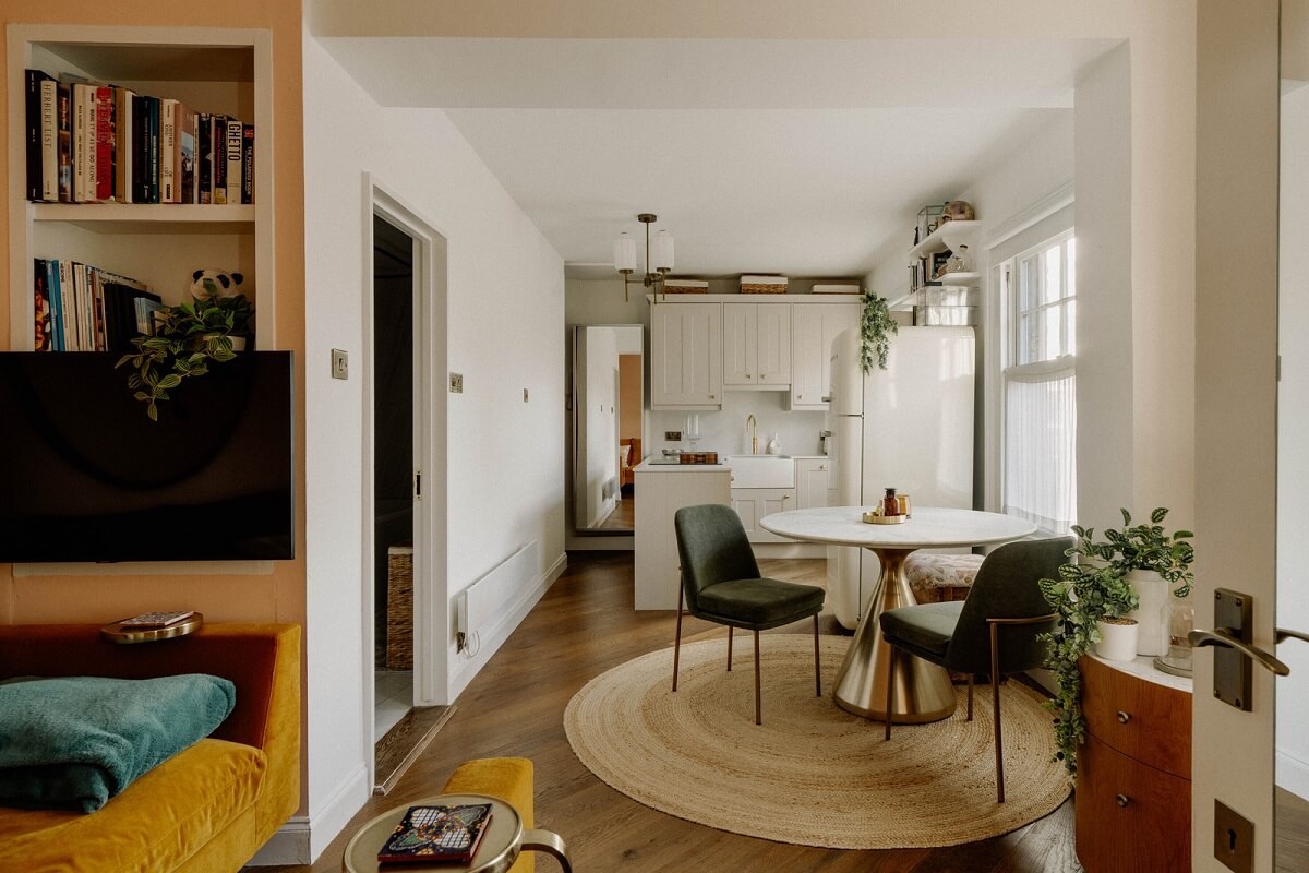 A Tiny London Apartment with Refined Materials and Colors 1 small open plan living room kitchen round dining table
