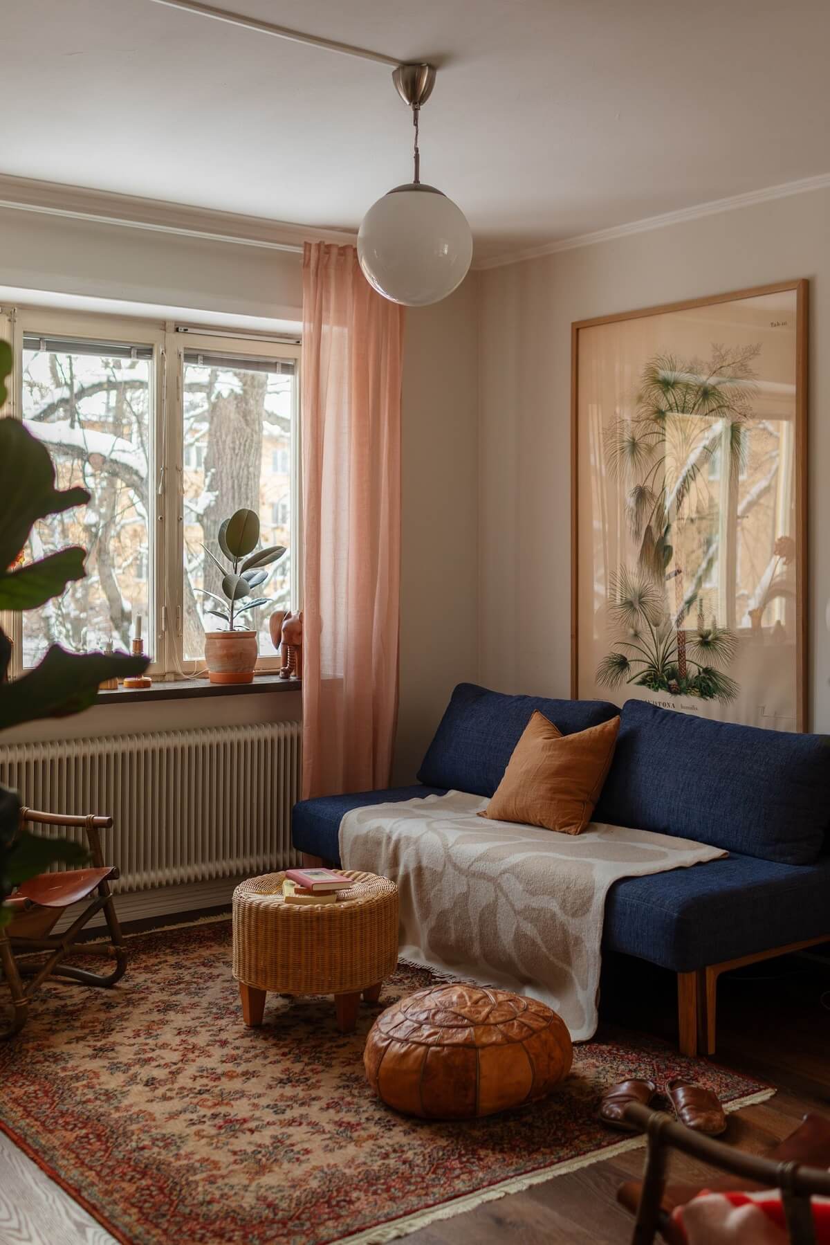 blue sofa in small living room with warm color accents nordroom