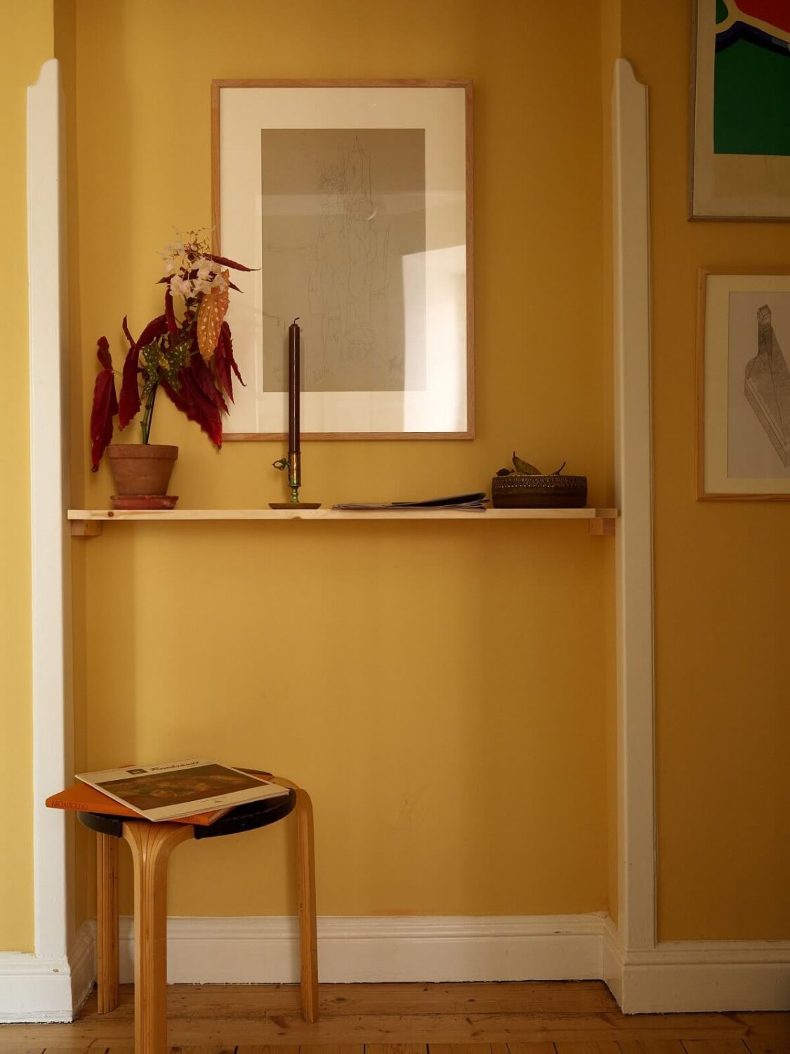 A Cozy Swedish Apartment Filled with Charm 14 shelf yellow hallway