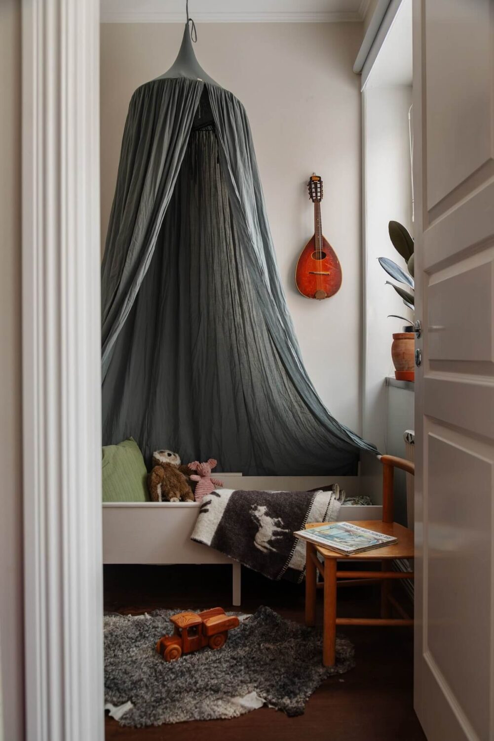 A Small Swedish Apartment with Warm Color Accents 18 small kids bedroom with gray canopy