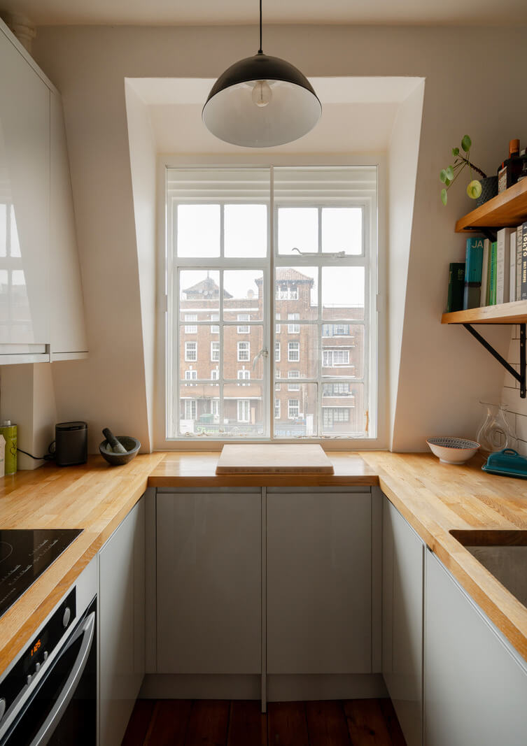 A Charming Top-Floor Apartment in an Art Deco Building 8 small kitchen with dormer window and wooden worktop nordroom