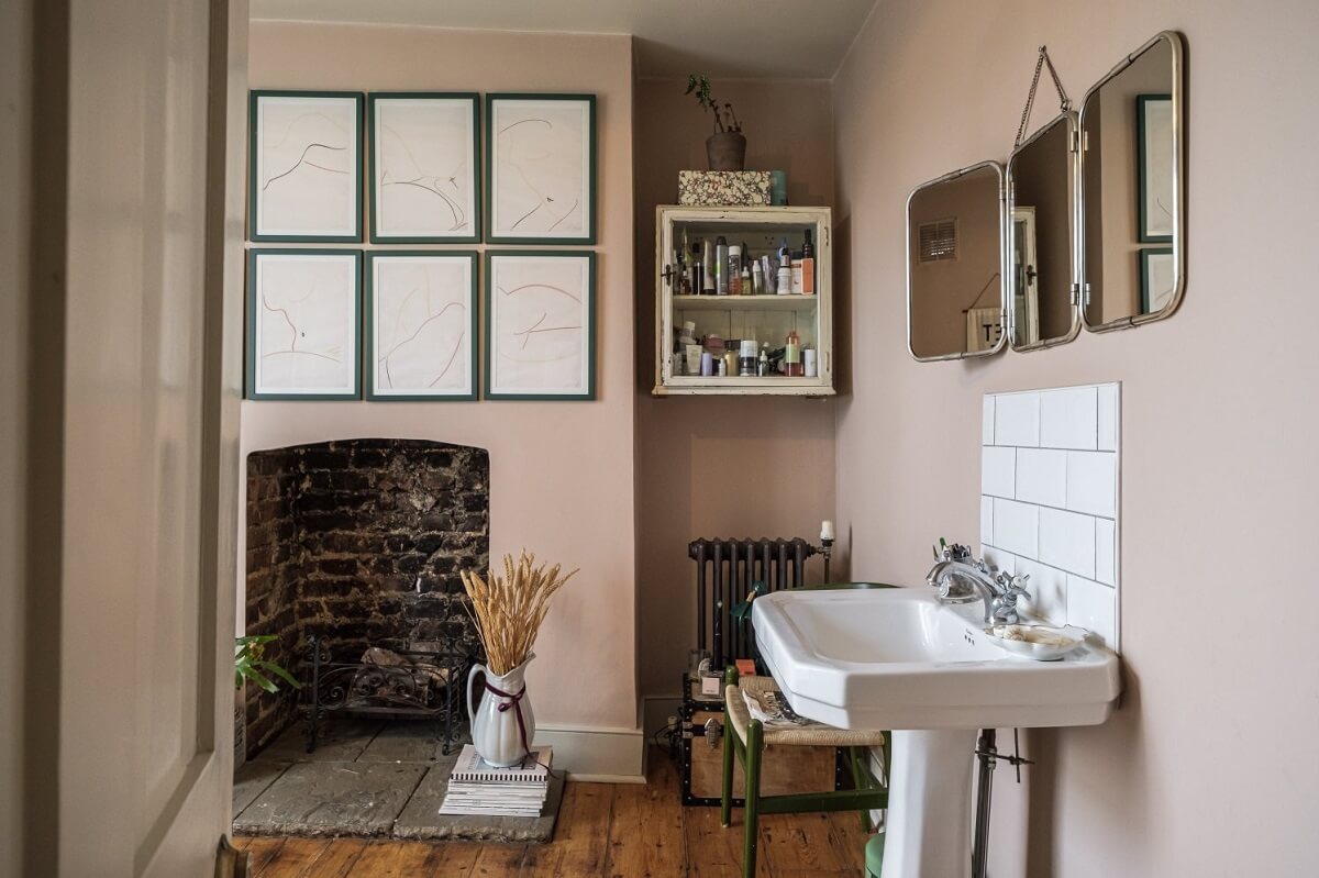 A Cozy and Charming Georgian Townhouse in London 24 vintage style bathroom with pink walls and brick fireplace