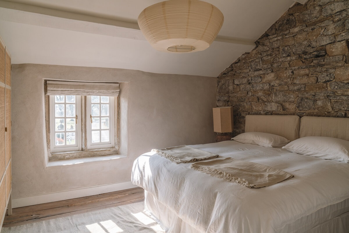Contemporary Interiors in a Historic English House 16 cottage bedroom with stone feature wall