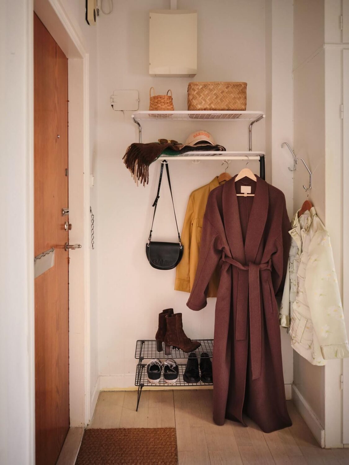 A Small Midcentury Apartment in Stockholm 13 hallway with shelves