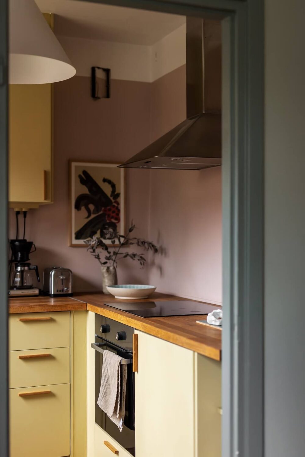 Colorful Kitchen Designs That Brighten Up Your Home 16 light pink walls and yellow kitchen cabinets
