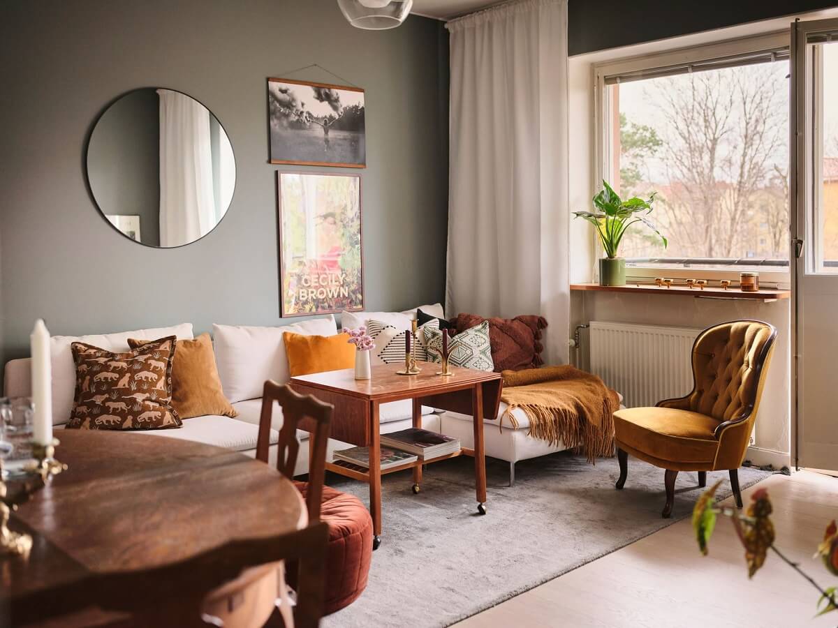 A Small Midcentury Apartment in Stockholm 1 midcentury living room with gray walls and ochre yellow accents