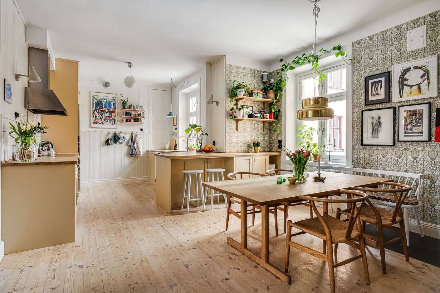 A Swedish Family Apartment with a Butter Yellow Kitchen 1 kitchen and dining space with wallpaper