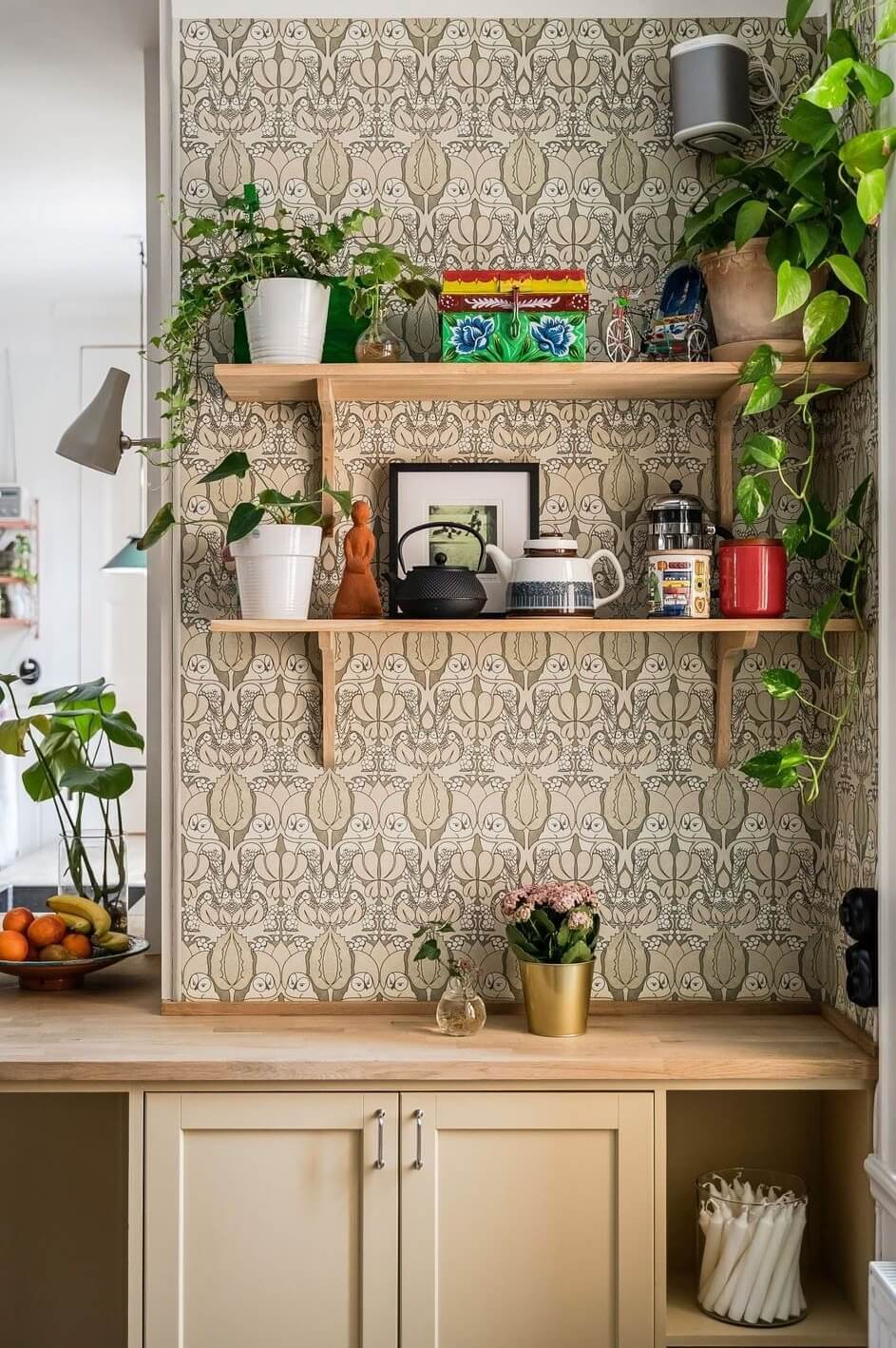 A Swedish Family Apartment with a Butter Yellow Kitchen 5 kitchen with shelves and wallpaper